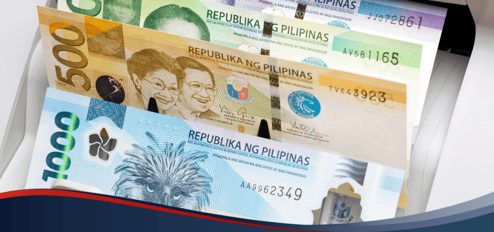 Peso bills on a counter, depicting Cebuana to bank transfer transactions