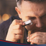 A pawnbroker assessing a gold bracelet in a pawnshop lending