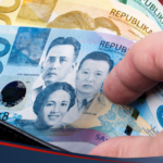 A person taking peso bills from a wallet, illustrating GCash cash-in transactions done in Cebuana Lhuillier branches