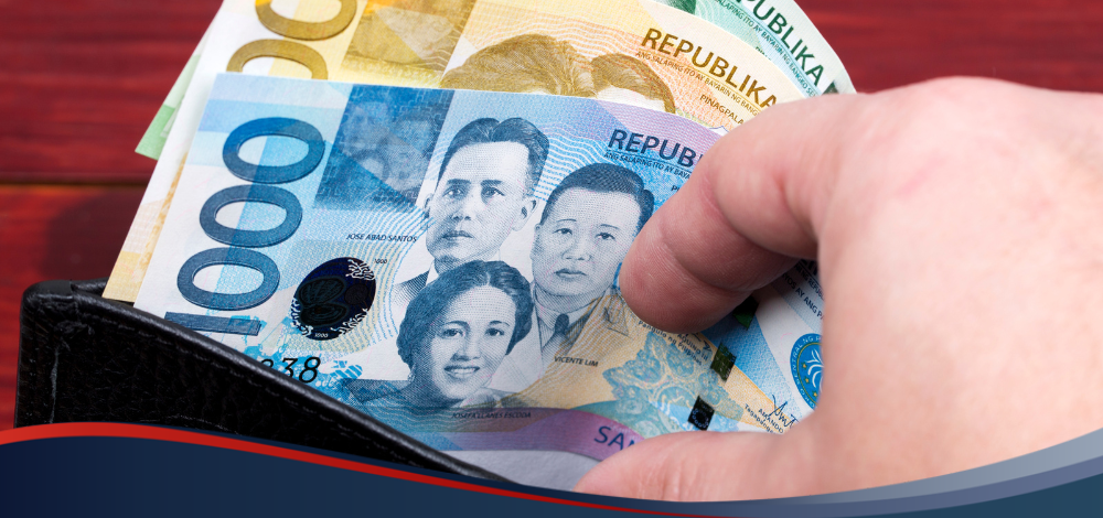 A person taking peso bills from a wallet, illustrating GCash cash-in transactions done in Cebuana Lhuillier branches